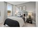 Cozy bedroom featuring a geometric accent wall, window with natural light, and comfortable furnishings at 1613 Caldwell Bend Ln, Dacula, GA 30019