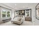 The spacious bedroom has large windows, a dark accent wall, and a tray ceiling at 1613 Caldwell Bend Ln, Dacula, GA 30019