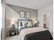 Cozy bedroom featuring a geometric accent wall, window with natural light, and comfortable furnishings at 1613 Caldwell Bend Ln, Dacula, GA 30019