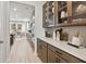 Butler's pantry with custom cabinets, backsplash, countertop and open access to dining area at 1613 Caldwell Bend Ln, Dacula, GA 30019