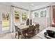 Bright dining area adjacent to the kitchen, featuring large windows and a view of the outdoors at 1613 Caldwell Bend Ln, Dacula, GA 30019