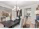 Spacious dining room featuring a modern chandelier and decor and light-colored walls at 1613 Caldwell Bend Ln, Dacula, GA 30019