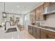 Modern kitchen with stainless steel appliances, light wood floors, and an island with seating at 1613 Caldwell Bend Ln, Dacula, GA 30019