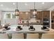 Well-lit kitchen with stainless steel appliances, an island with seating, and modern finishes at 1613 Caldwell Bend Ln, Dacula, GA 30019