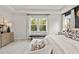 Inviting main bedroom featuring large windows, tray ceiling, neutral carpeting and ample natural light at 1613 Caldwell Bend Ln, Dacula, GA 30019
