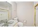Bathroom featuring a shower with gold trim, toilet, and vanity with a mirror at 2303 Pine Heights Ne Dr, Atlanta, GA 30324