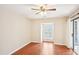 Bedroom featuring hardwood floors, a ceiling fan, and a sliding door to the balcony at 2303 Pine Heights Ne Dr, Atlanta, GA 30324