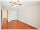 Bedroom featuring hardwood floors, a ceiling fan, and a closet with doors at 2303 Pine Heights Ne Dr, Atlanta, GA 30324