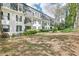 Exterior of building featuring black trimmed windows, balconies, and professionally maintained landscaping at 2303 Pine Heights Ne Dr, Atlanta, GA 30324