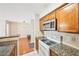 Well-lit kitchen showcasing granite countertops, an oven, and stainless steel microwave at 2303 Pine Heights Ne Dr, Atlanta, GA 30324