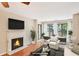 Staged living room with fireplace and balcony access; a warm and inviting space to relax and enjoy at 2303 Pine Heights Ne Dr, Atlanta, GA 30324