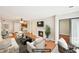 Staged living room with hardwood floors, fireplace, and access to balcony creating a cozy and inviting space at 2303 Pine Heights Ne Dr, Atlanta, GA 30324