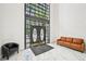 Bright lobby area featuring contemporary furniture and marble flooring with high ceilings and a wall of windows at 2303 Pine Heights Ne Dr, Atlanta, GA 30324