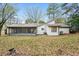 Backyard view of a home with a screened in porch at 2938 Parkwood Rd, Snellville, GA 30039