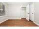 A bright bedroom with wood-look floors and a closet at 2938 Parkwood Rd, Snellville, GA 30039