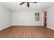 Bedroom features wood floors, neutral paint and a window with horizontal blinds that provide natural light at 2938 Parkwood Rd, Snellville, GA 30039