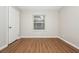 Bedroom featuring wood floors, neutral paint, and a large window with blinds at 2938 Parkwood Rd, Snellville, GA 30039