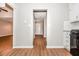 Hallway features wood floors, neutral paint and leads to the home's front door and other rooms at 2938 Parkwood Rd, Snellville, GA 30039