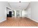 Open-concept living room with wood floors, sliding doors, and access to the kitchen, promotes seamless flow at 2938 Parkwood Rd, Snellville, GA 30039