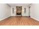 Living room features a floor to ceiling stone fireplace, wood floors, neutral paint, and natural light at 2938 Parkwood Rd, Snellville, GA 30039