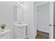 Bright bathroom with a white vanity, mirror with lights, and neutral walls at 49 Country Ct, Alpharetta, GA 30005