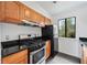 Well-lit kitchen featuring wooden cabinets, stainless steel appliances and black granite countertops at 49 Country Ct, Alpharetta, GA 30005