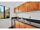 Updated kitchen with granite counters, wood cabinetry, and stainless steel dishwasher at 49 Country Ct, Alpharetta, GA 30005
