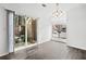 Open living space with sliding glass doors leading to outdoor patio and lots of light at 49 Country Ct, Alpharetta, GA 30005