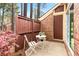 Private patio area includes a white table and chairs, brick exterior, and wooden fence at 49 Country Ct, Alpharetta, GA 30005