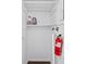 The utility closet features shelves, cleaning supplies, plumbing, and a fire extinguisher at 49 Country Ct, Alpharetta, GA 30005