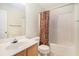 The bathroom features a shower-tub combo and a sink with vanity, next to a toilet at 7324 Drake Ave, Lithonia, GA 30058