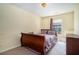 Cozy bedroom featuring neutral walls, carpeted floors, and a comfortable bed with patterned bedding at 7324 Drake Ave, Lithonia, GA 30058