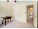 A well-lit room with neutral walls features a table, carpeted flooring, and several doors at 7324 Drake Ave, Lithonia, GA 30058