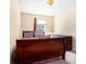 A well-lit bedroom features carpet flooring, a wooden dresser, and a comfortable bed with patterned bedding at 7324 Drake Ave, Lithonia, GA 30058