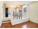 Dining room with hardwood floors, open to kitchen area with a black refrigerator at 7324 Drake Ave, Lithonia, GA 30058