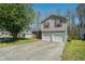 Charming two-story home with brick and siding exterior and a two-car garage at 7324 Drake Ave, Lithonia, GA 30058