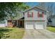Charming two-story home with brick and siding exterior and a two-car garage at 7324 Drake Ave, Lithonia, GA 30058