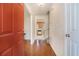 Inviting foyer with hardwood floors leading to a kitchen view and staircase at 7324 Drake Ave, Lithonia, GA 30058