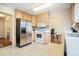 Functional kitchen with light wood cabinets and stainless-steel refrigerator at 7324 Drake Ave, Lithonia, GA 30058
