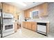 Functional kitchen with light wood cabinets and modern appliances at 7324 Drake Ave, Lithonia, GA 30058