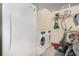 The laundry area features a washer, dryer, and a fridge, next to cleaning supplies at 7324 Drake Ave, Lithonia, GA 30058