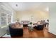 Bright living room featuring hardwood floors, large window, and comfortable seating at 7324 Drake Ave, Lithonia, GA 30058