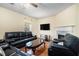 Comfortable living room featuring a fireplace, dark furniture, and hardwood floors at 7324 Drake Ave, Lithonia, GA 30058