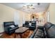 A cozy living room with hardwood floors and a comfortable black leather sofa set at 7324 Drake Ave, Lithonia, GA 30058