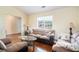 Cozy living room with plush sofas, hardwood floors, and natural light from a window at 7324 Drake Ave, Lithonia, GA 30058