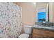 Neat bathroom with granite countertop, wood cabinets, and butterfly shower curtain at 765 Rock Ln, Mcdonough, GA 30253