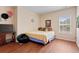 Cozy bedroom with wood floors, a bright window and neutral walls at 765 Rock Ln, Mcdonough, GA 30253