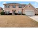 Charming two-story home featuring a two-car garage and well-maintained landscaping at 765 Rock Ln, Mcdonough, GA 30253