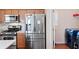 Modern kitchen featuring stainless steel appliances and adjacent laundry room at 765 Rock Ln, Mcdonough, GA 30253
