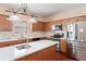 Modern kitchen with stainless steel appliances, white countertops, and wood cabinets at 765 Rock Ln, Mcdonough, GA 30253